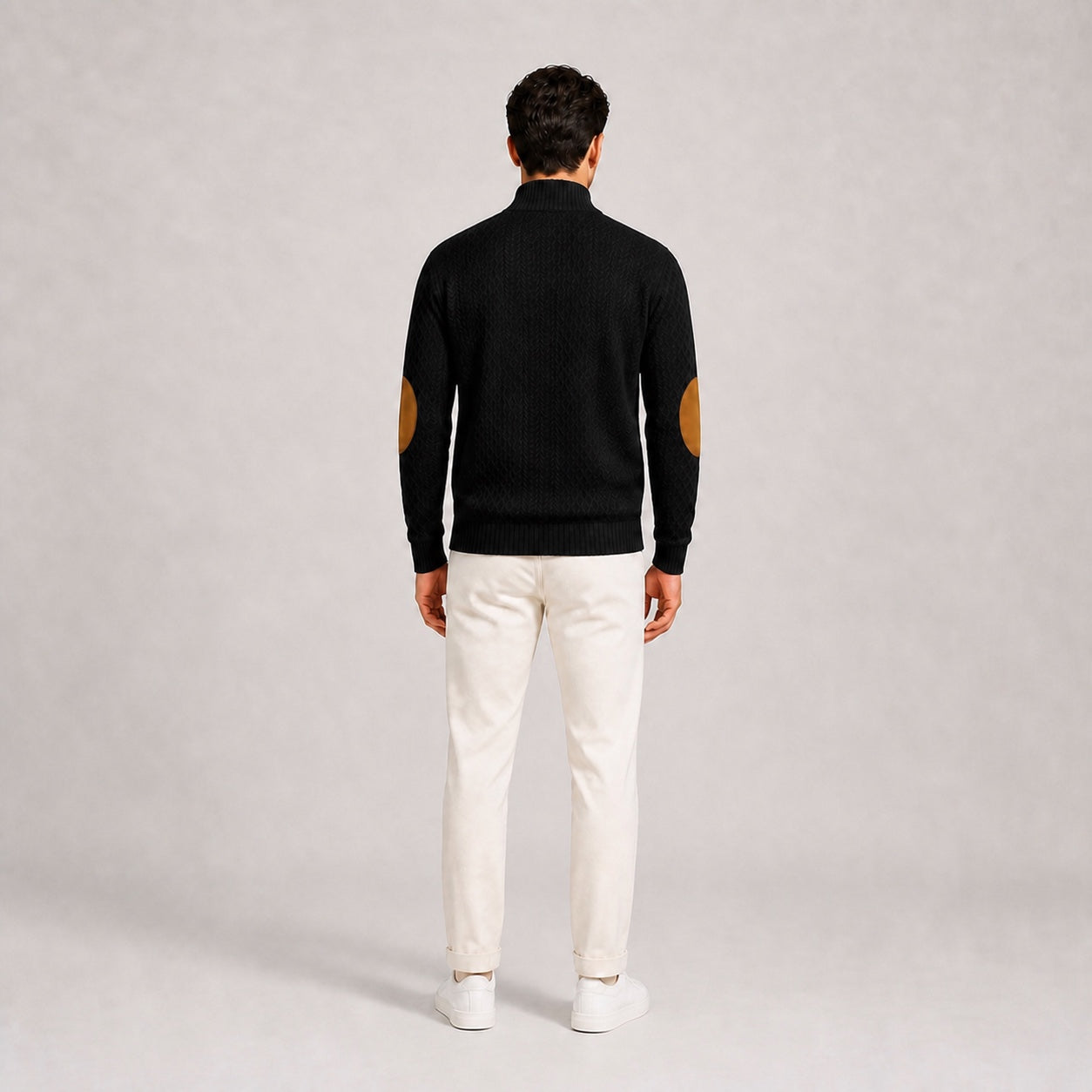 Model wearing the Black men's textured stand-collar pullover with white trousers, back full-body studio view