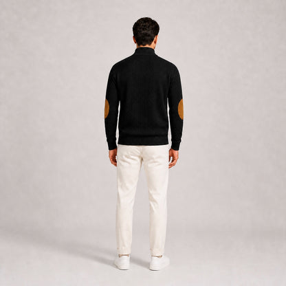 Model wearing the Black men's textured stand-collar pullover with white trousers, back full-body studio view