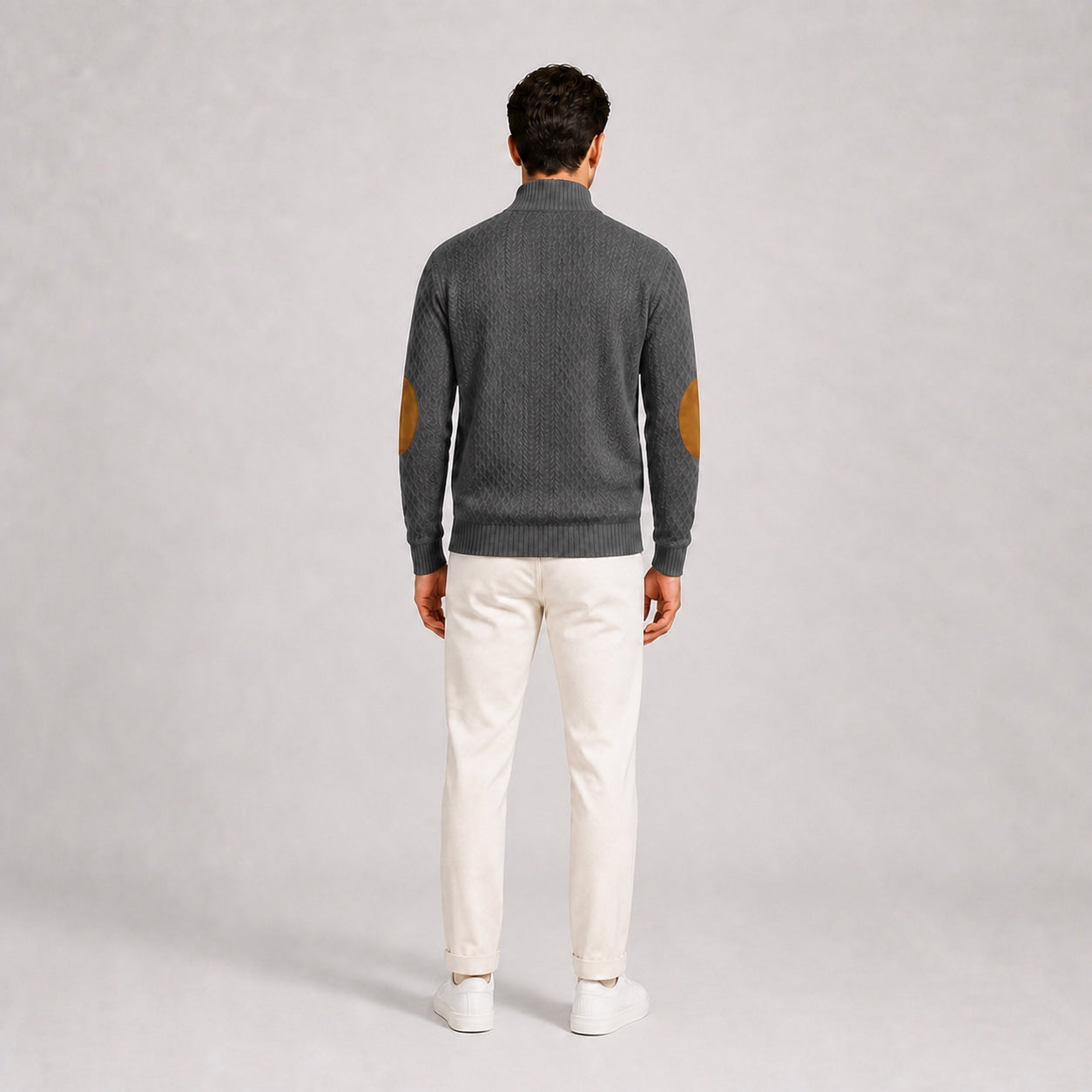 Model wearing the Charcoal Grey men's textured stand-collar pullover with white trousers, back full-body studio view