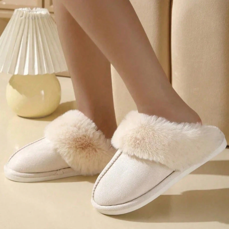 Beige warm slippers worn on an indoor floor