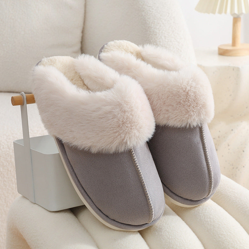 Light grey warm slippers displayed on a stool