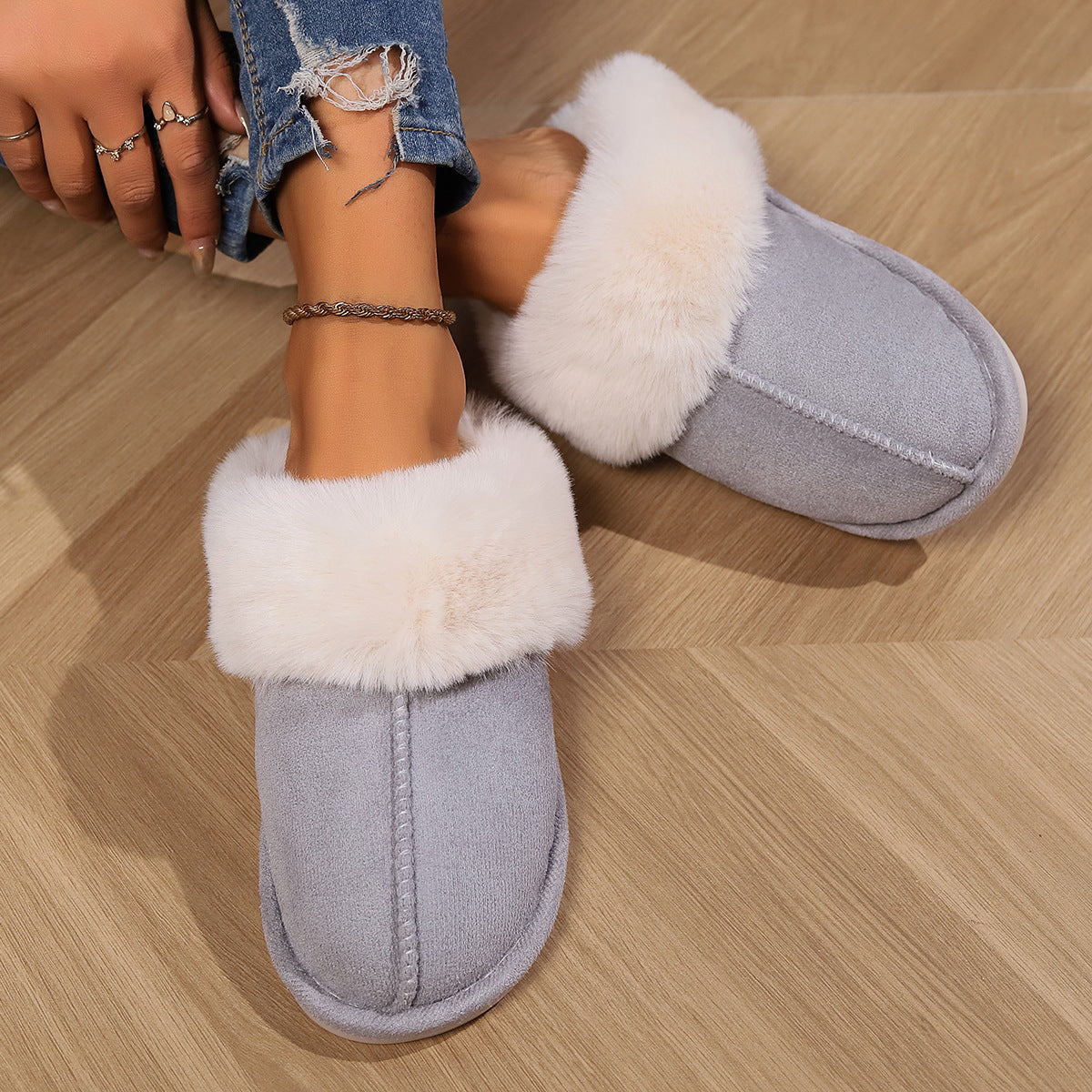 Light grey slipper shown close up while being worn