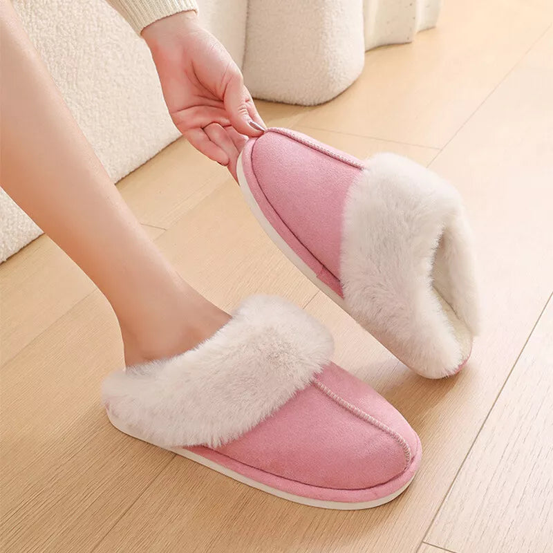 Pink warm slipper shown while being put on