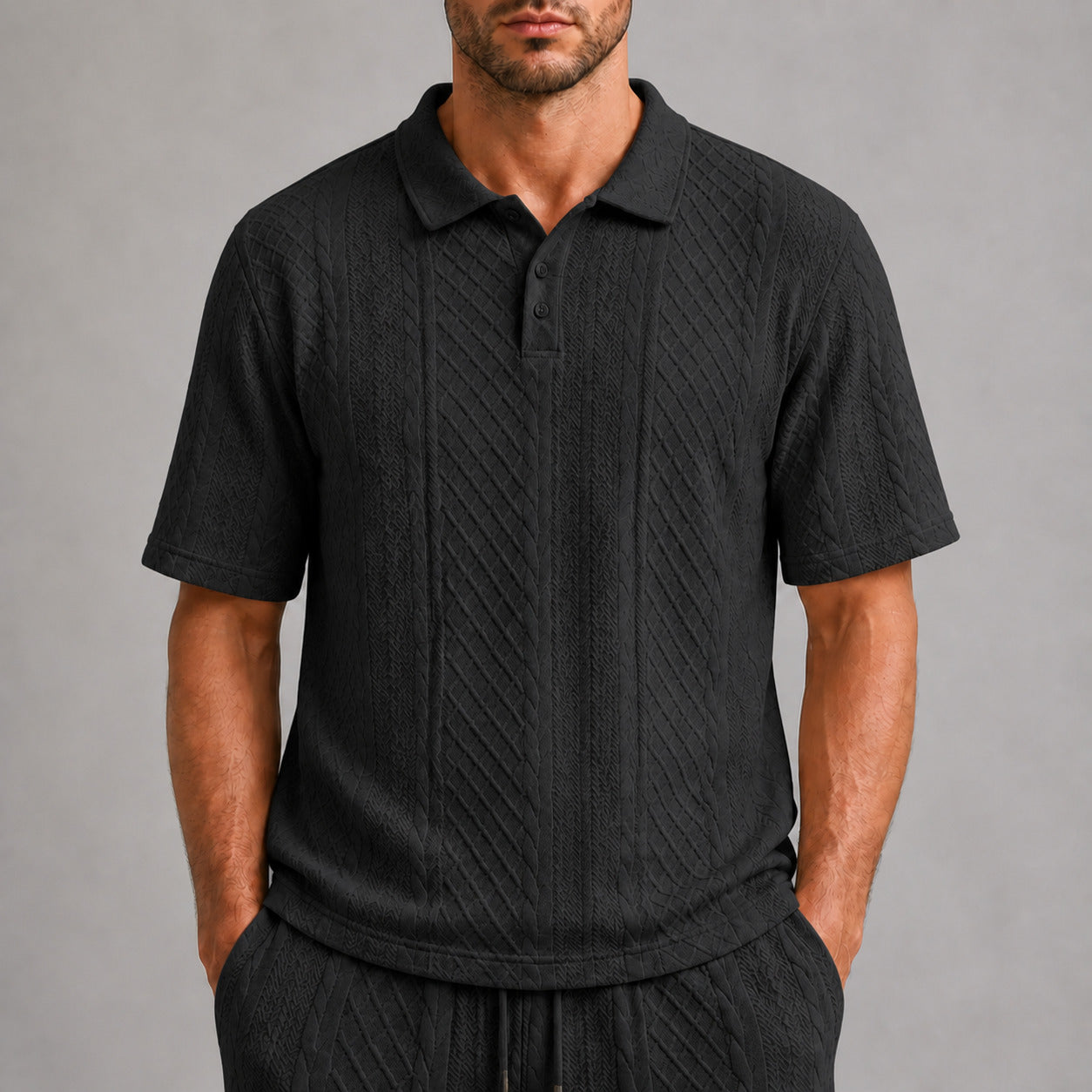 Black men's textured jacquard polo shirt, raised geometric texture close-up
