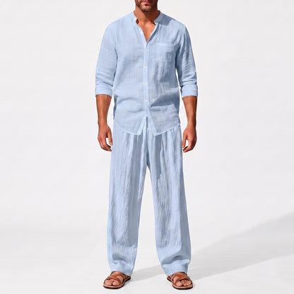 Blue men's two piece linen-blend set with Grandad collar shirt and straight-leg trousers, closer front outfit view