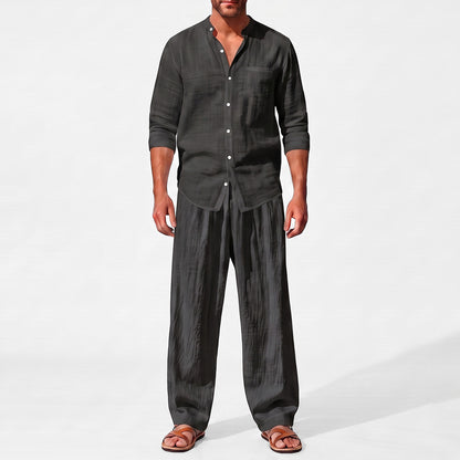 Black men's two piece linen-blend set with Grandad collar shirt and straight-leg trousers, closer front outfit view