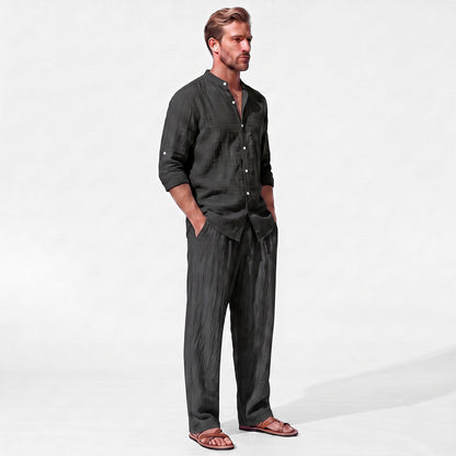 Black men's two piece linen-blend set with Grandad collar shirt and straight-leg trousers, three-quarter model view