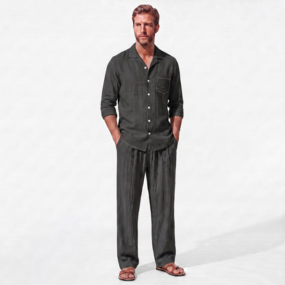 Black men's two piece linen-blend set with Grandad collar shirt and straight-leg trousers, front model view with hands in pockets
