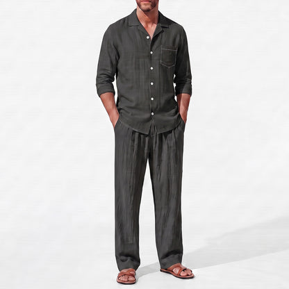 Black men's two piece linen-blend set with Grandad collar shirt and straight-leg trousers, close front outfit detail