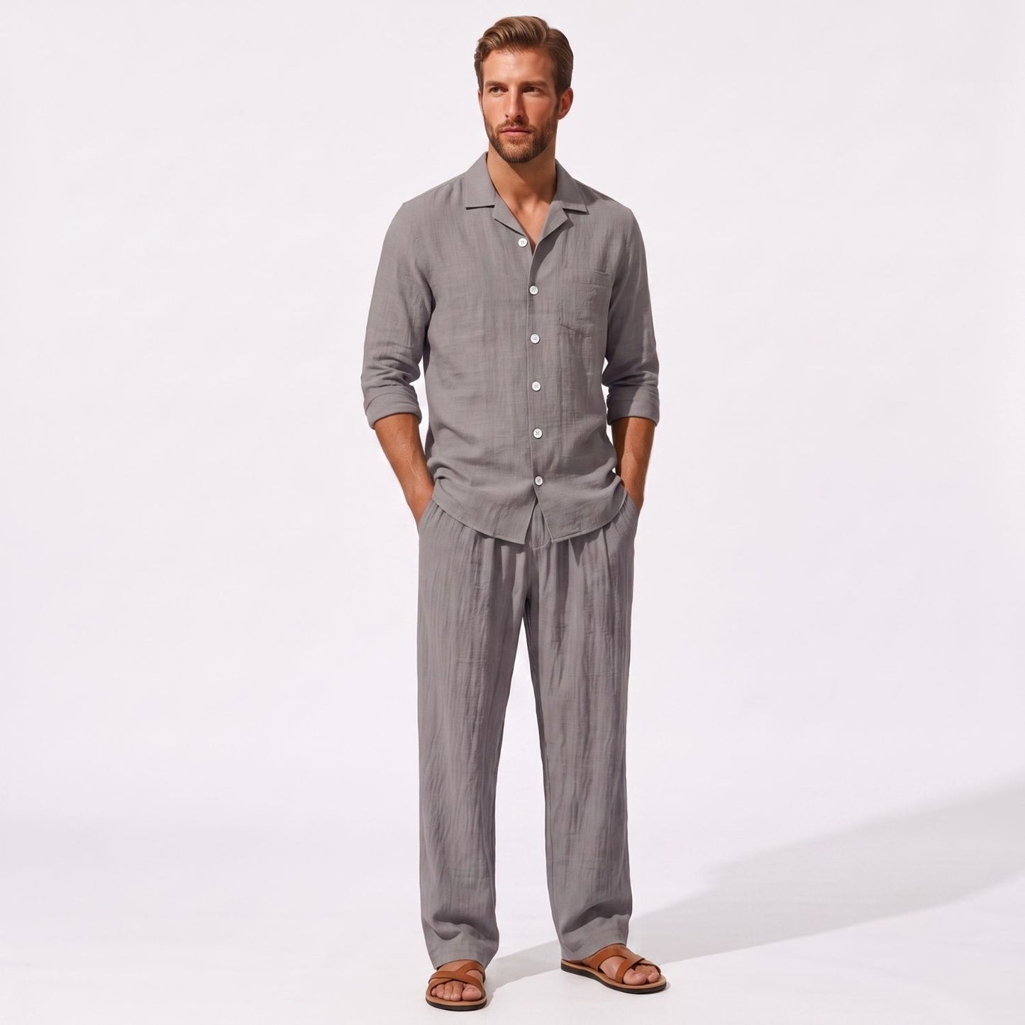 Grey men's two piece linen-blend set with Grandad collar shirt and straight-leg trousers, front model view with hands in pockets
