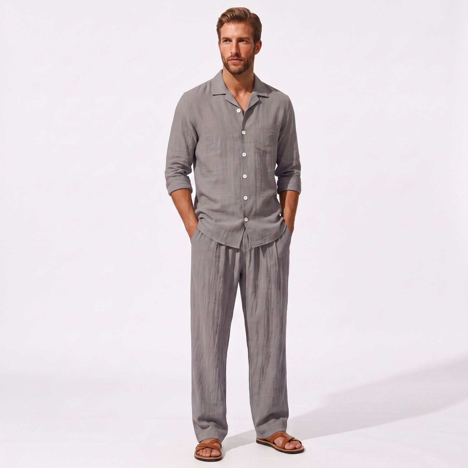 Grey men's two piece linen-blend set with Grandad collar shirt and straight-leg trousers, front model view with hands in pockets