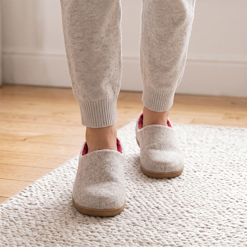 White house slippers with red lining, shown from the front while worn