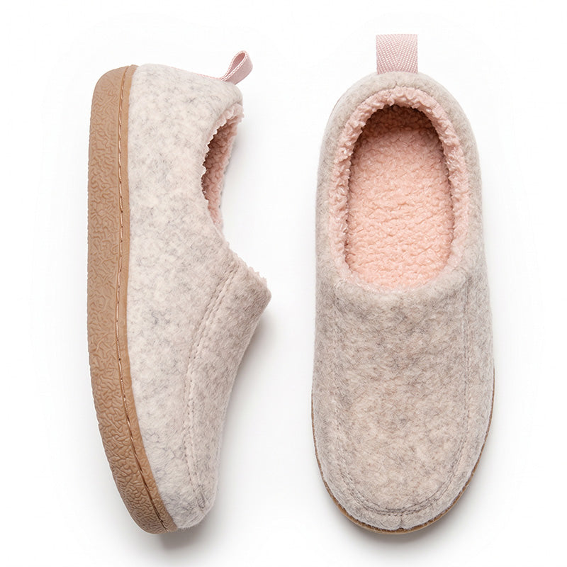 Pink house slippers in top and side views, showing plush pink lining and tan sole edges