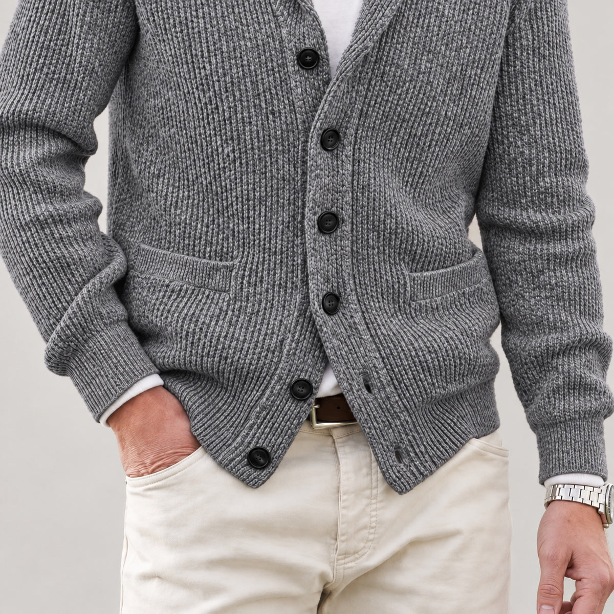 Front patch pockets, knit texture and lower hem on the grey cardigan
