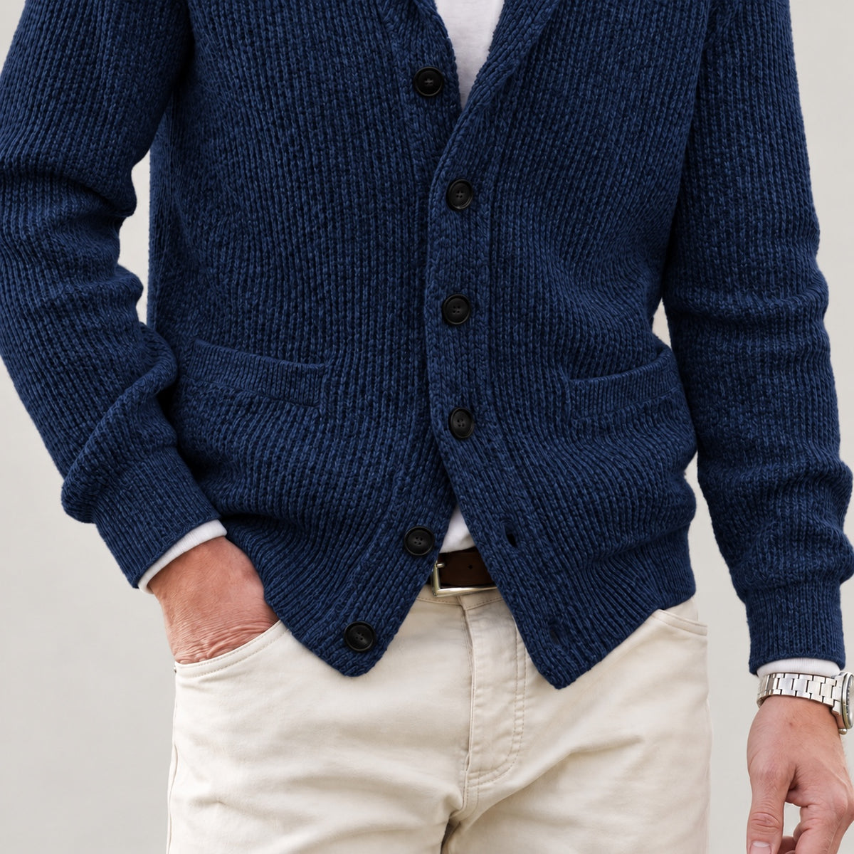 Front patch pockets, knit texture and lower hem on the navy cardigan