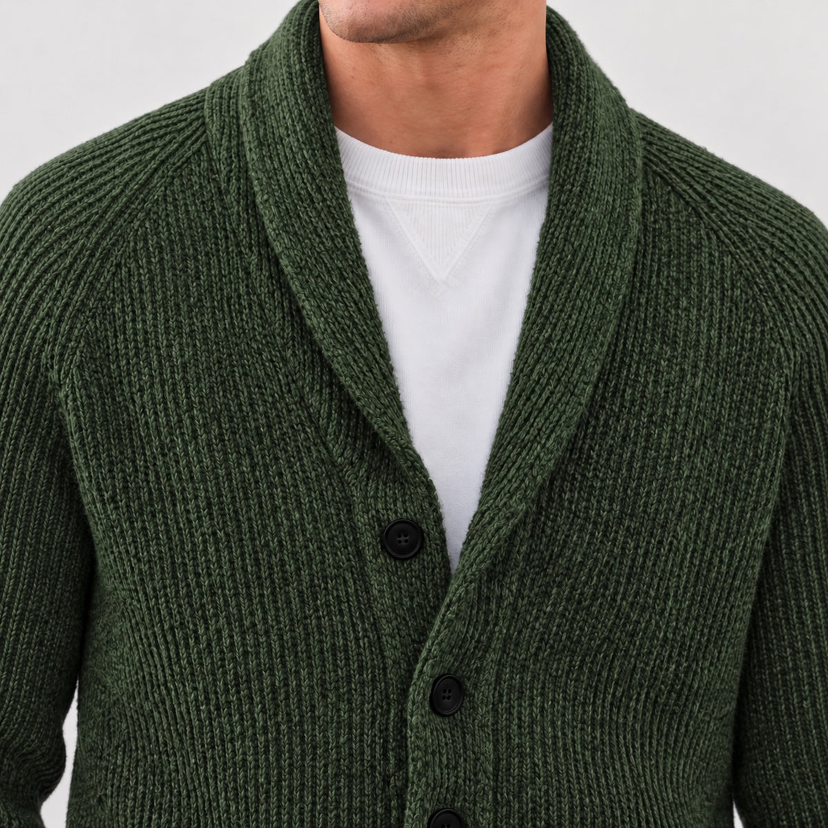Shawl collar and upper front button detail on the olive green cardigan