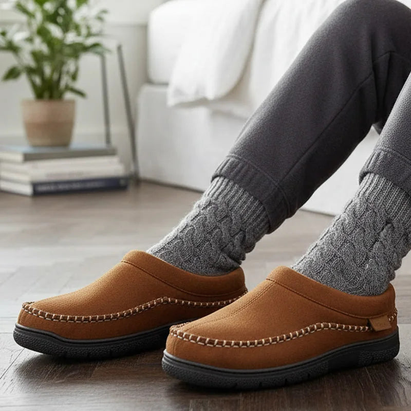 Light brown house slippers worn with grey socks, side view indoors