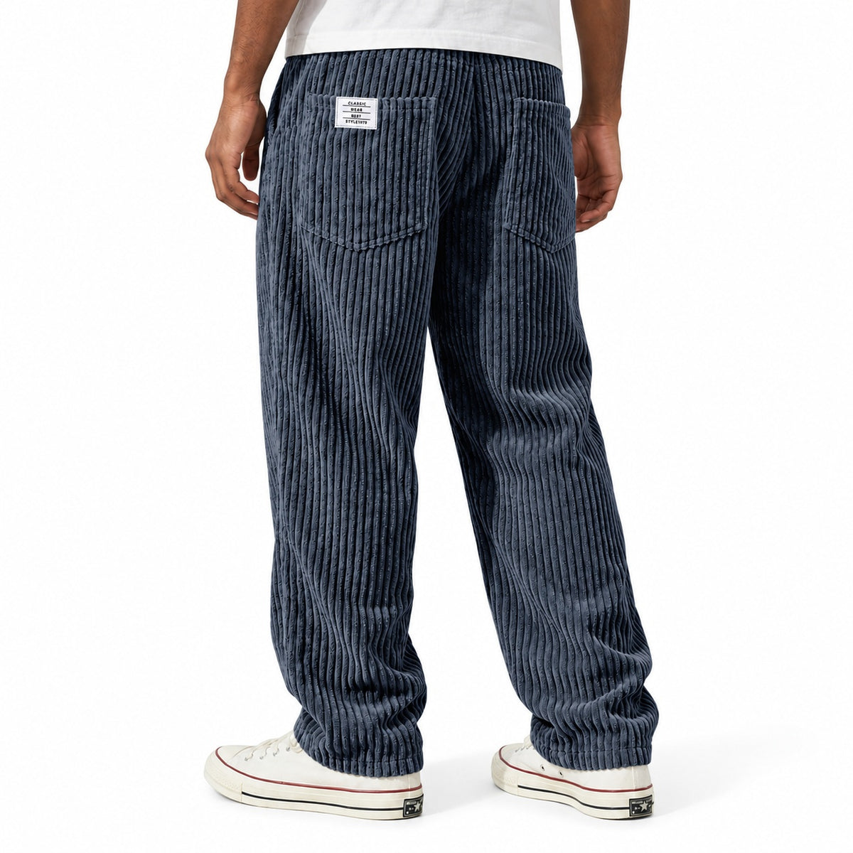 Navy ribbed straight-leg trousers shown from the rear three-quarter, with elasticated waist and rear patch pockets