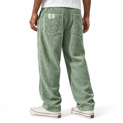 Sage Green ribbed straight-leg trousers shown from the rear three-quarter, with elasticated waist and rear patch pockets