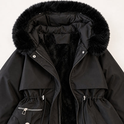 Close view of the black parka’s soft-trimmed hood, plush inner lining, layered chest panels and drawcord waist.