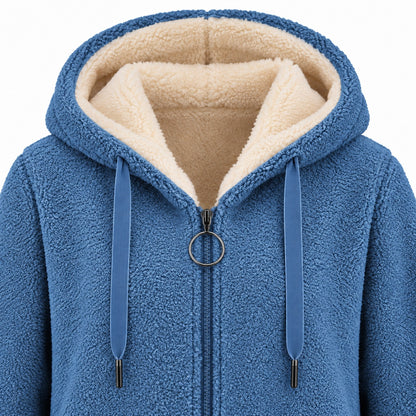 Blue longline sherpa hoodie, hood, cream lining, flat drawstrings and circular zipper pull detail.