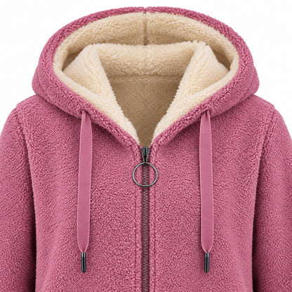 Pink longline sherpa hoodie, hood, cream lining, flat drawstrings and circular zipper pull detail.