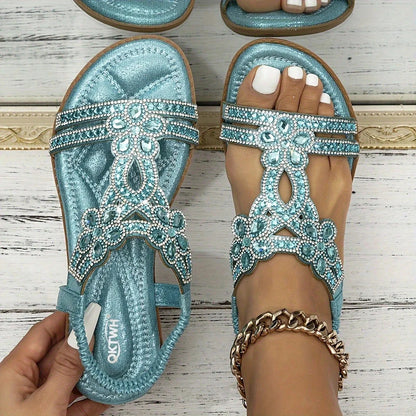 Light blue embellished slingback sandals, pair on pale wood background