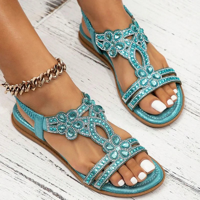 Light blue rhinestone slingback sandals, side on-foot wood-floor view