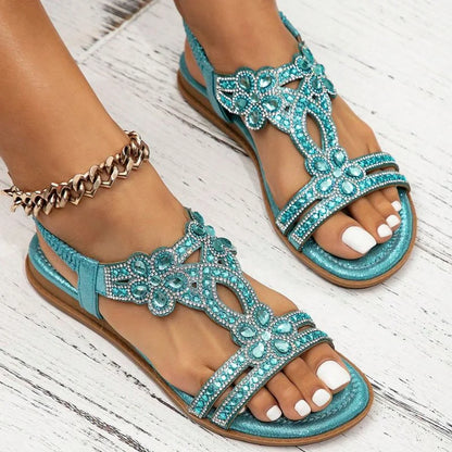 Light blue rhinestone slingback sandals, side on-foot wood-floor view
