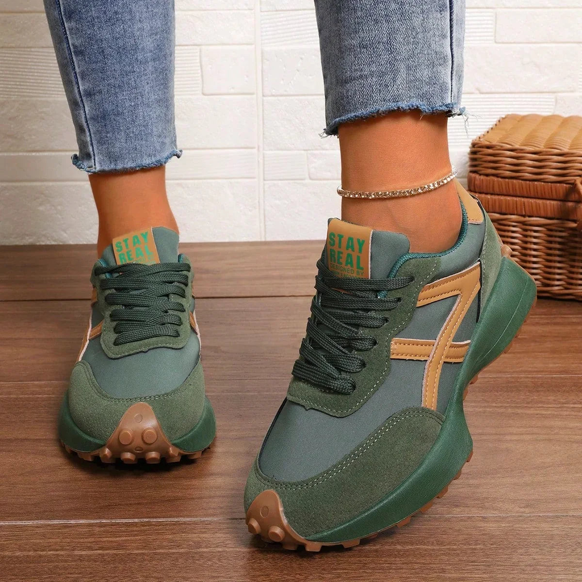 Women's green and orange walking trainers worn from the front