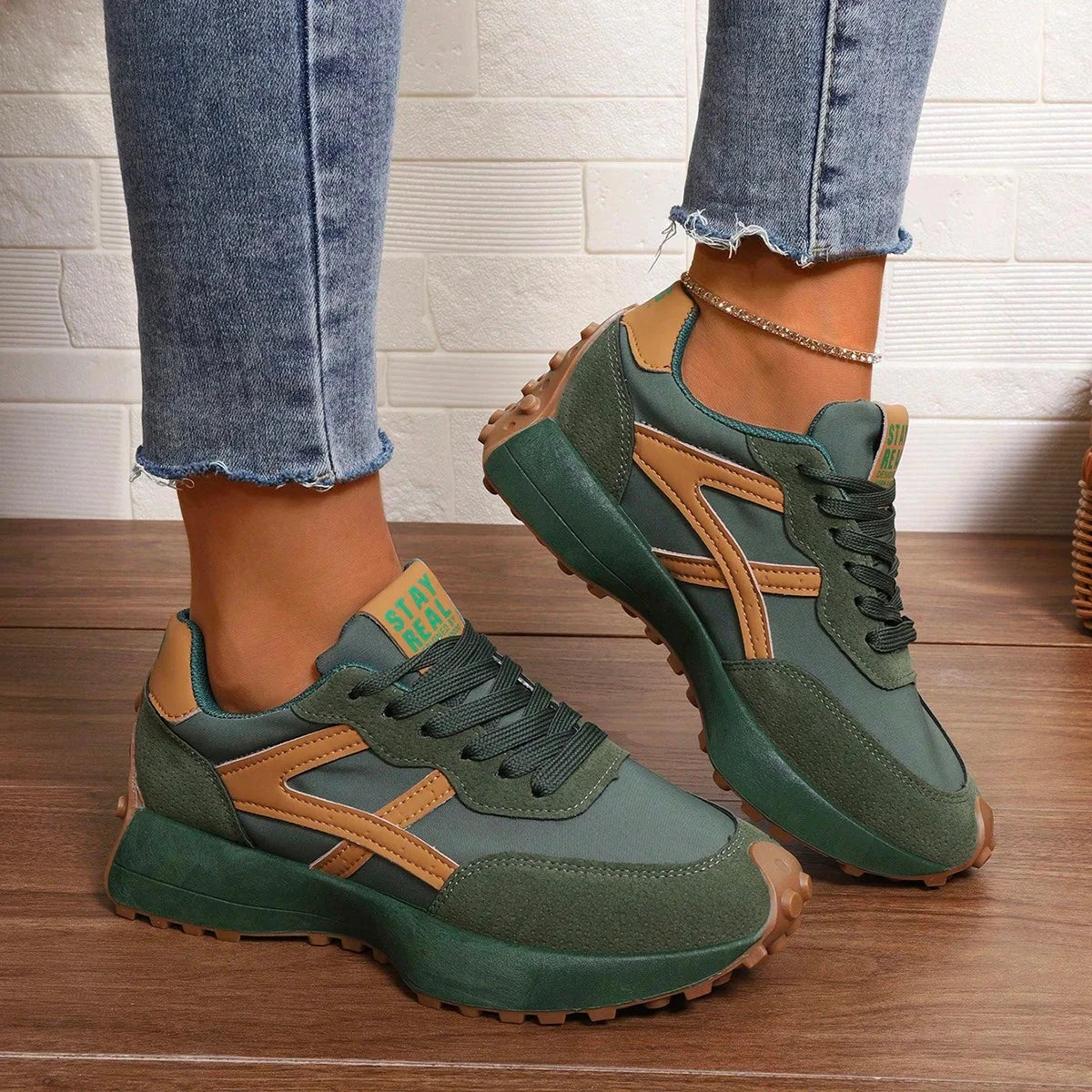 Women's green and orange walking trainers in a front three-quarter view
