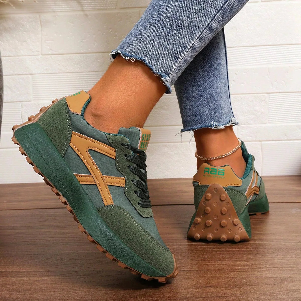 Women's green and orange walking trainers worn in side profile