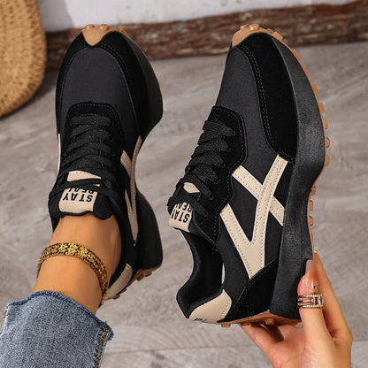 Women's black and cream walking trainers viewed from above