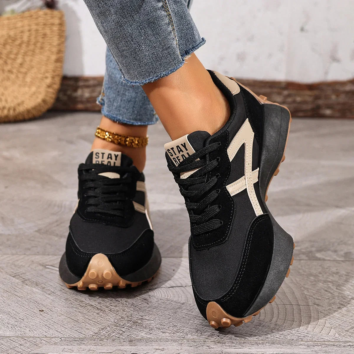 Women's black and cream walking trainers in a front three-quarter view