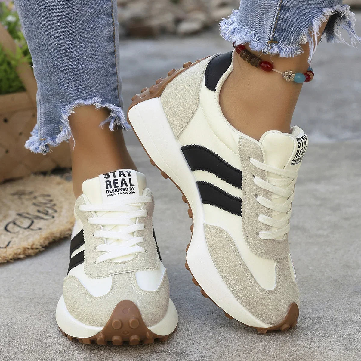 Women's white and black walking trainers worn from the front