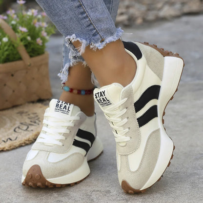 Women's white and black walking trainers in a front three-quarter view