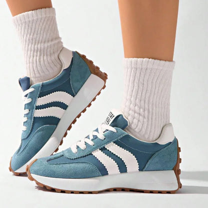 Women's blue and white walking trainers worn with white socks