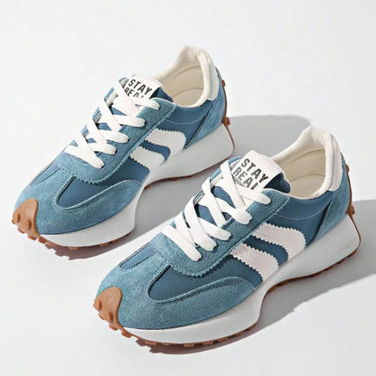 Pair of women's blue and white walking trainers viewed from above