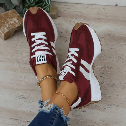 Pair of women's burgundy and white walking trainers viewed from above