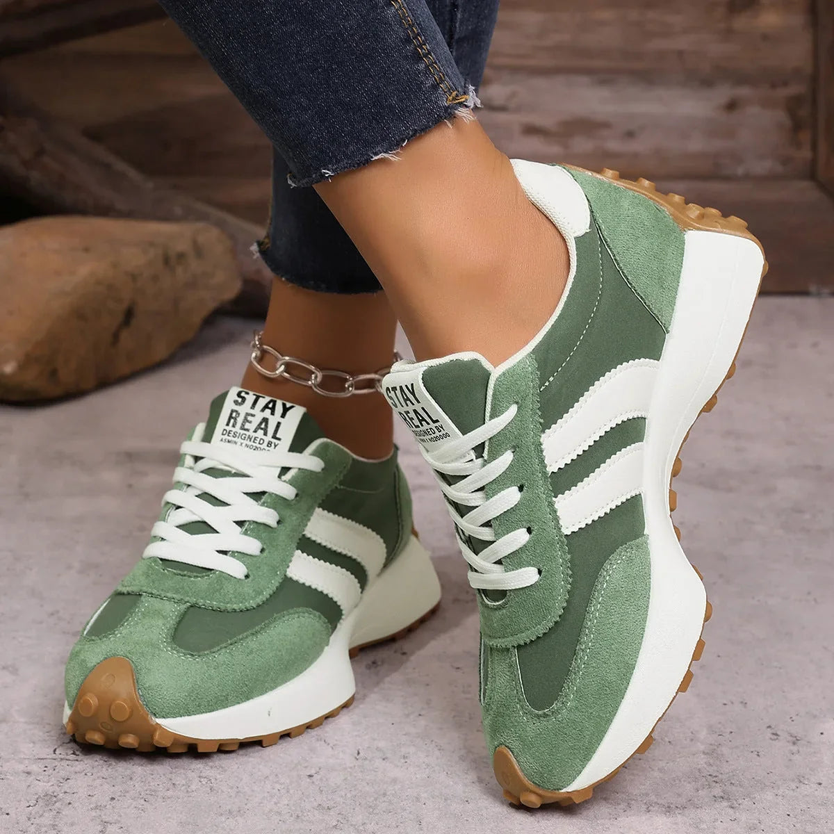 Women's green and white walking trainers worn from the front