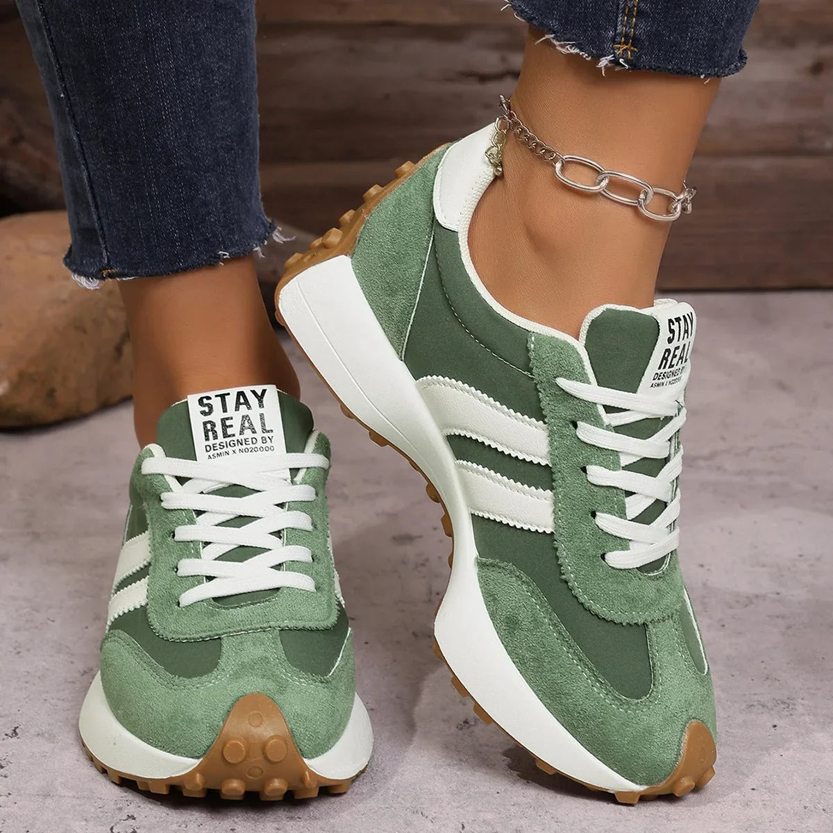 Women's green and white walking trainers in a front three-quarter view