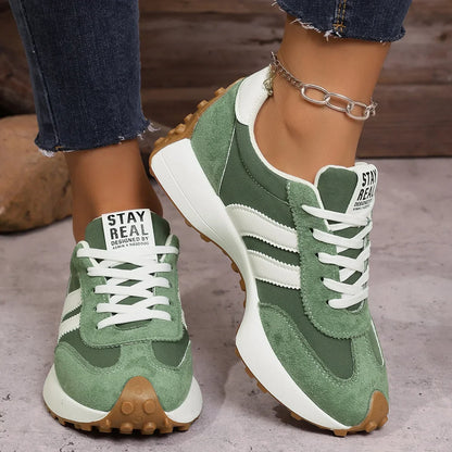 Women's green and white walking trainers in a front three-quarter view