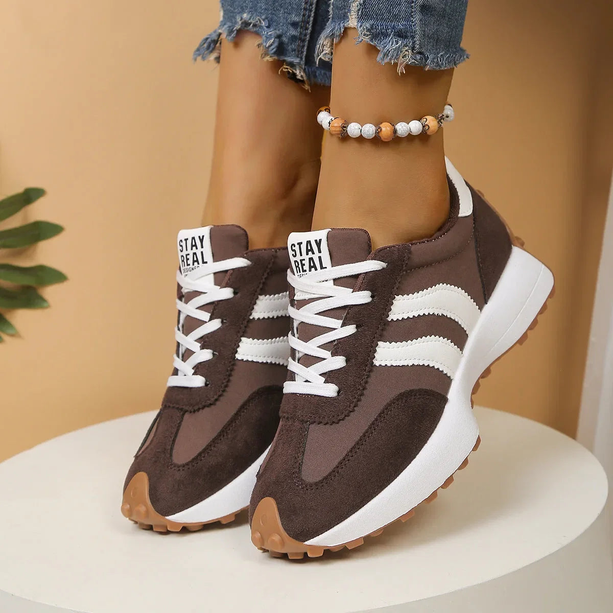 Women's brown and white walking trainers in a front three-quarter view
