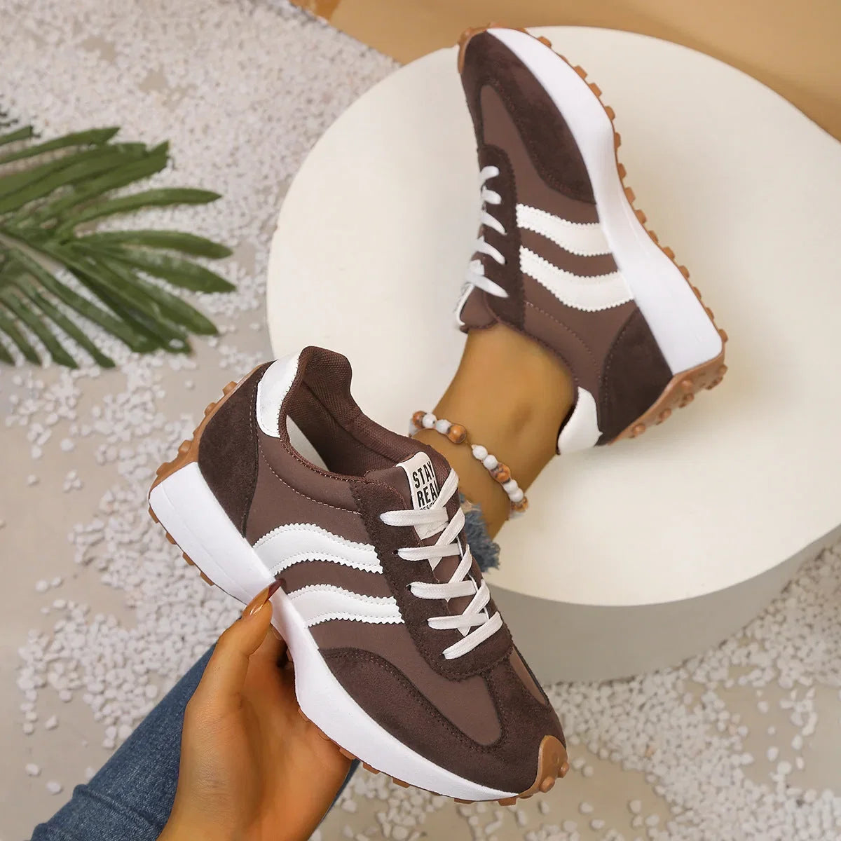 Pair of women's brown and white walking trainers viewed from above