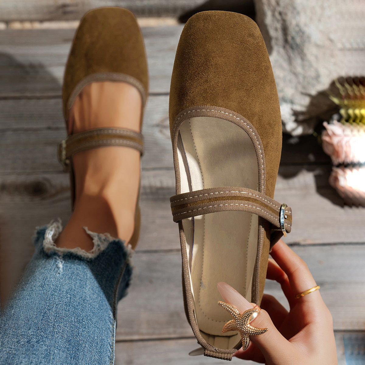 Tan women's Mary Jane flats showing the buckle strap and pale lining