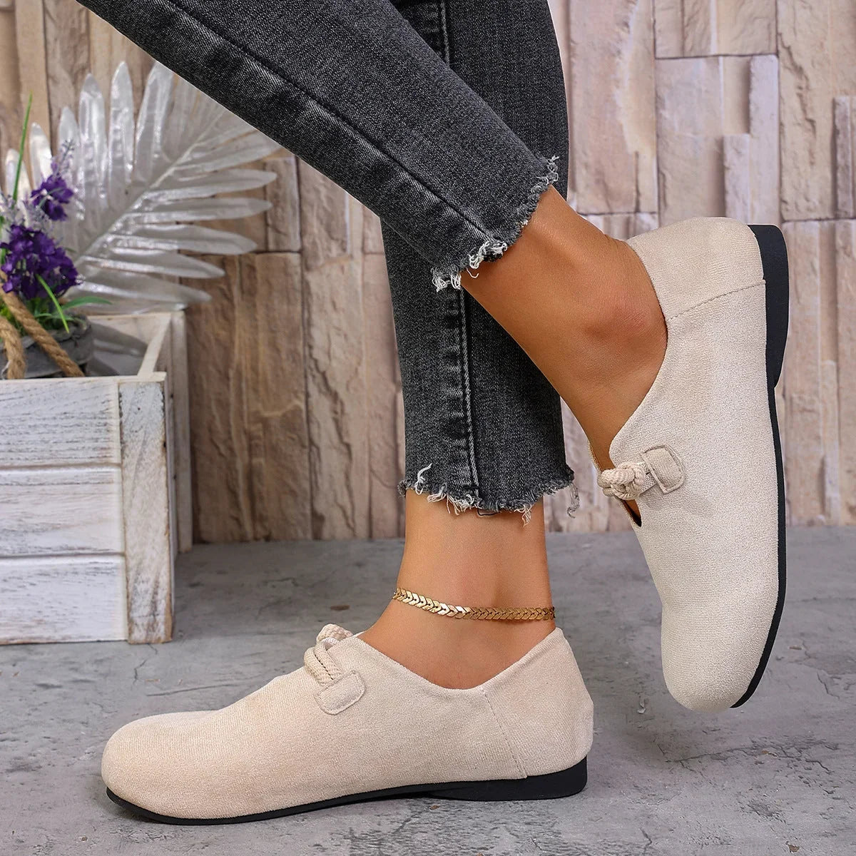 Beige soft flats with bow detail, side on-foot view