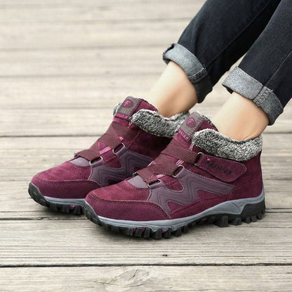 Red winter boots with fleece collars worn outdoors