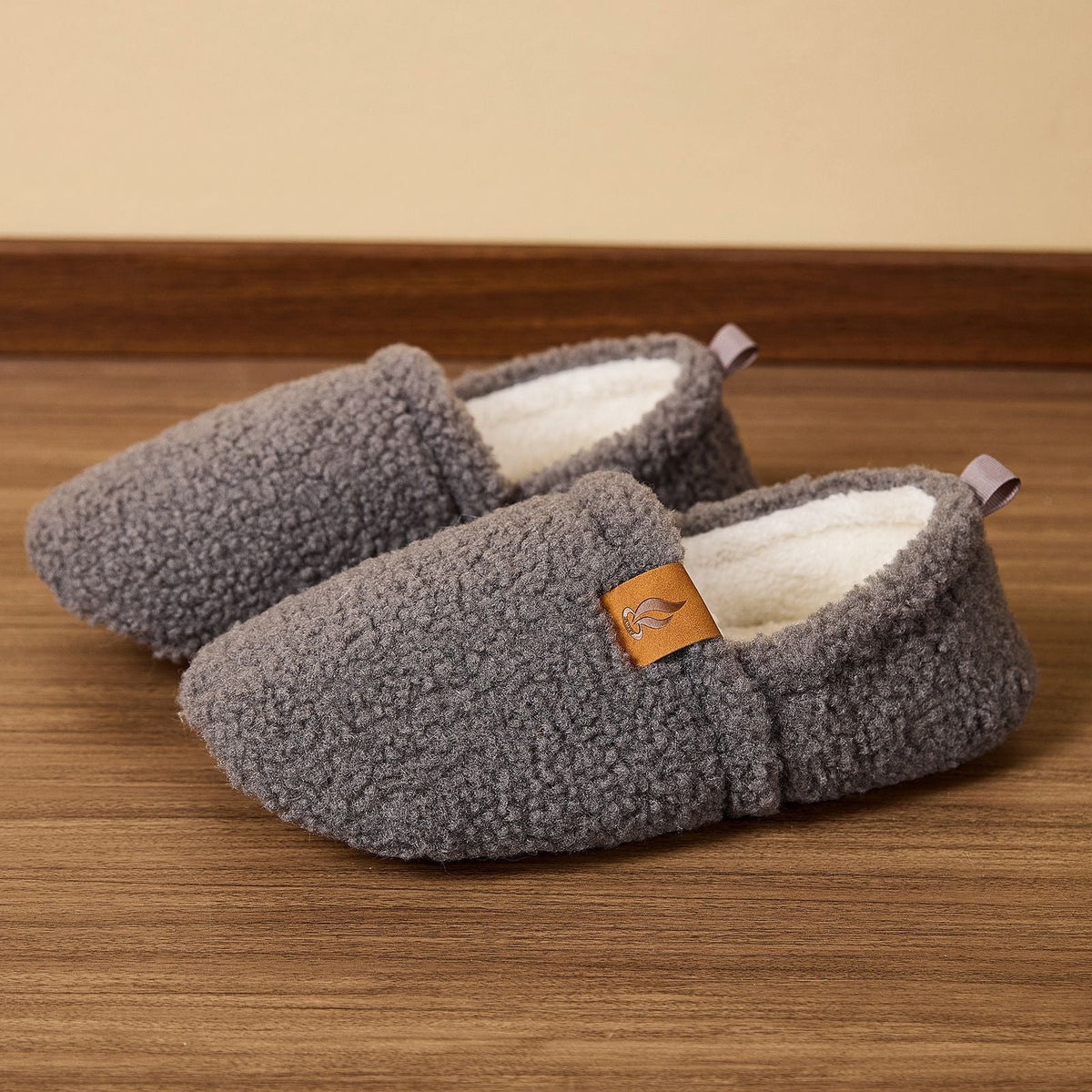 Auldweave women's warm shearling slippers – grey pair on a wooden floor