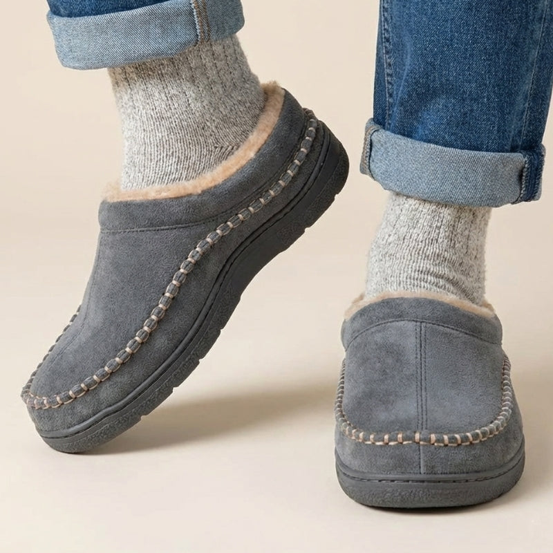 Grey fleece-lined moccasin slippers worn with socks
