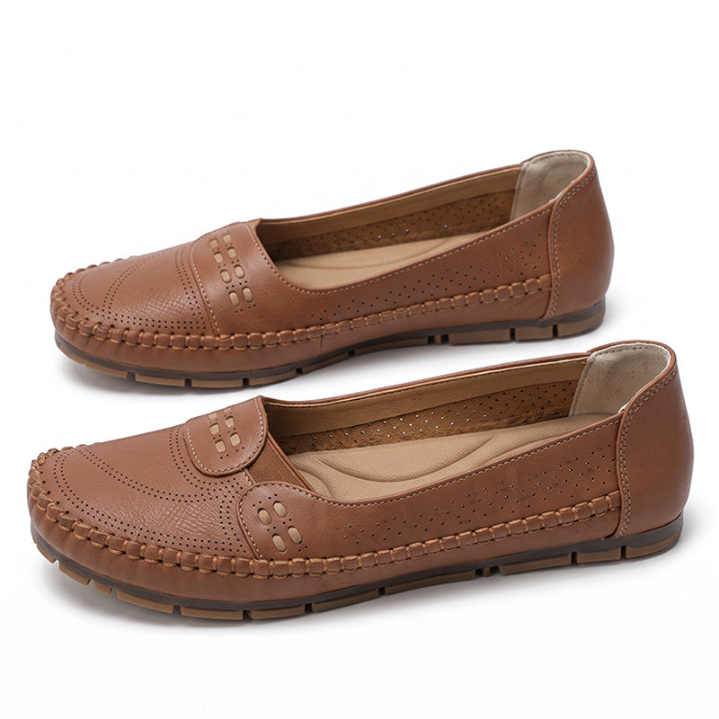 Tan women's wide fit leather loafers with perforated uppers and stitched edges, pair in side view